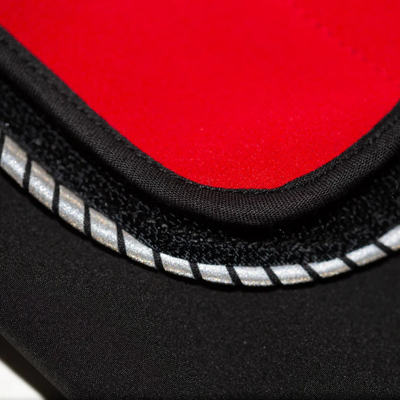 Close-up of a red belly wrap attached to hook lined with reflective striping